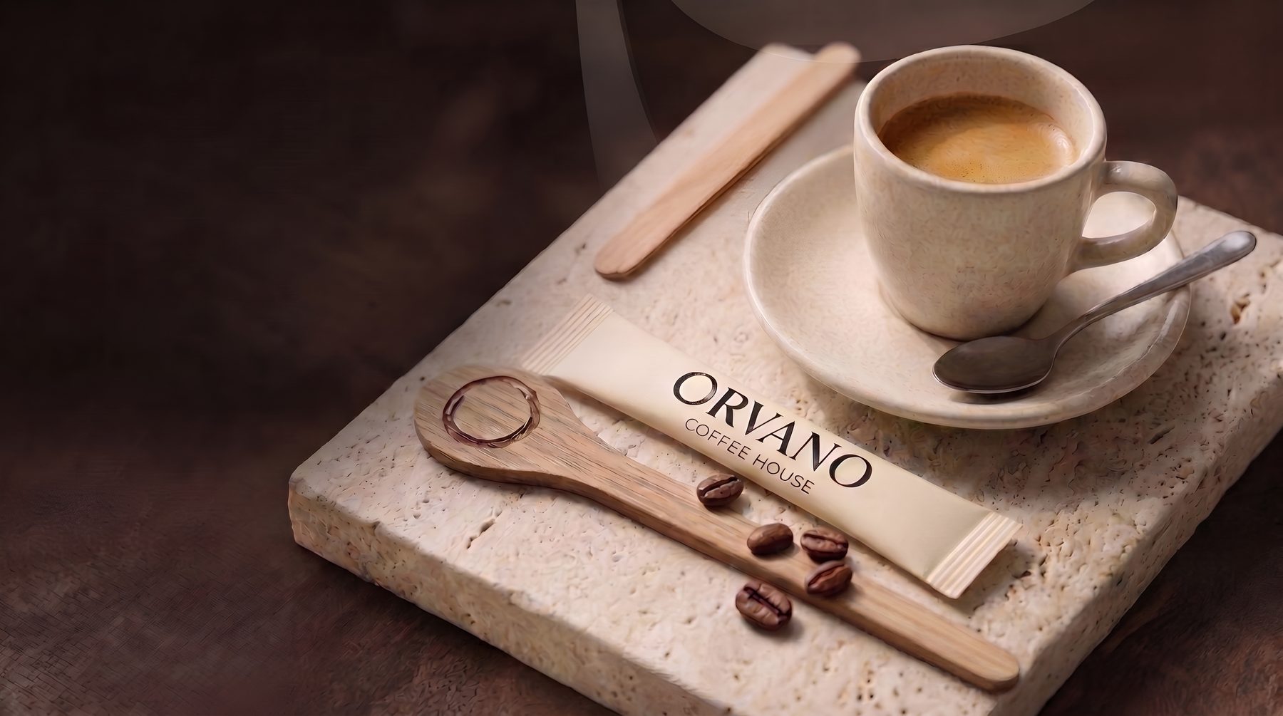 An espresso, saucer and branded ORVANO sugar stick on stone